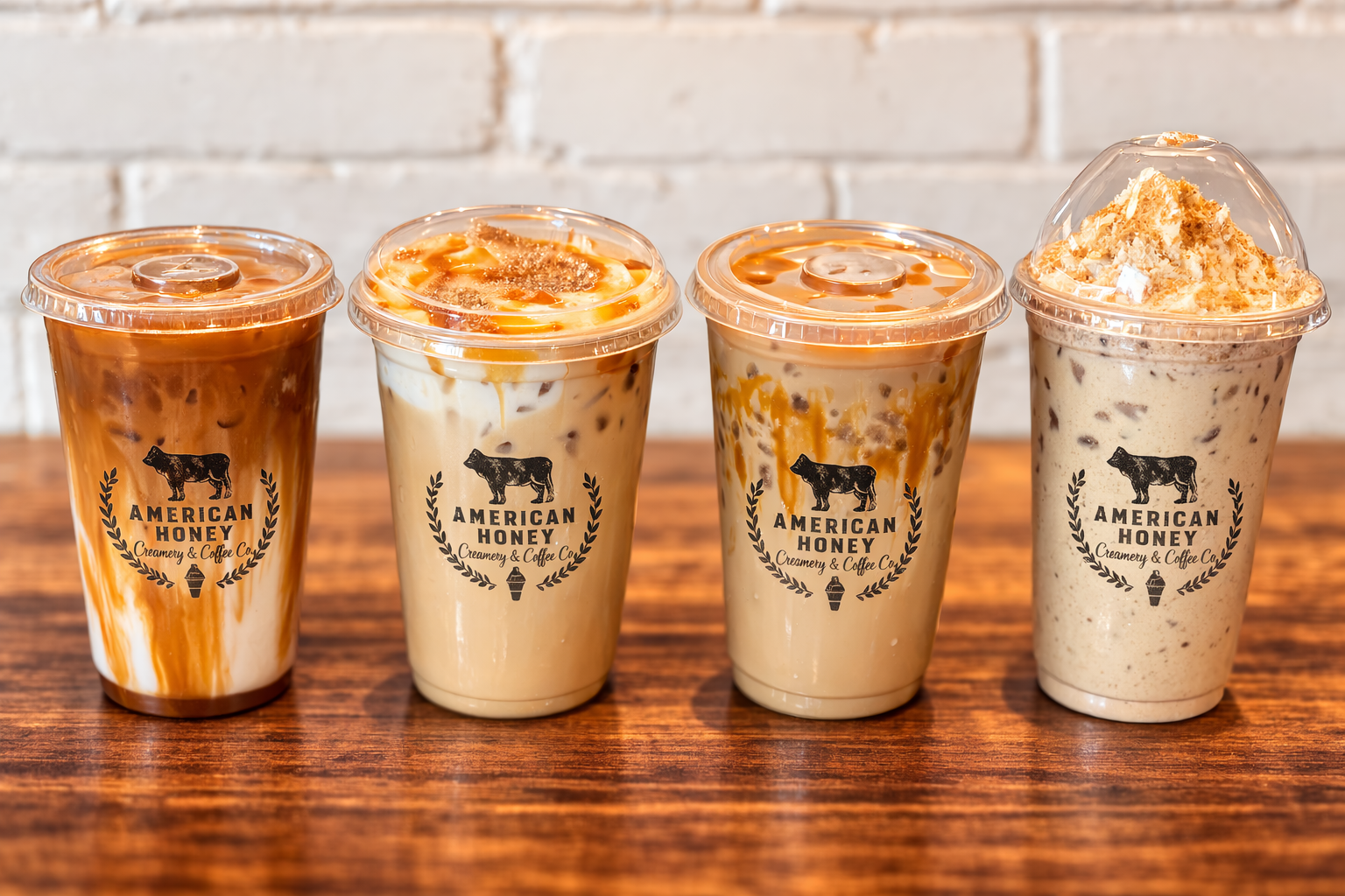 Four branded American Honey iced drinks lined up on a warm wooden counter
