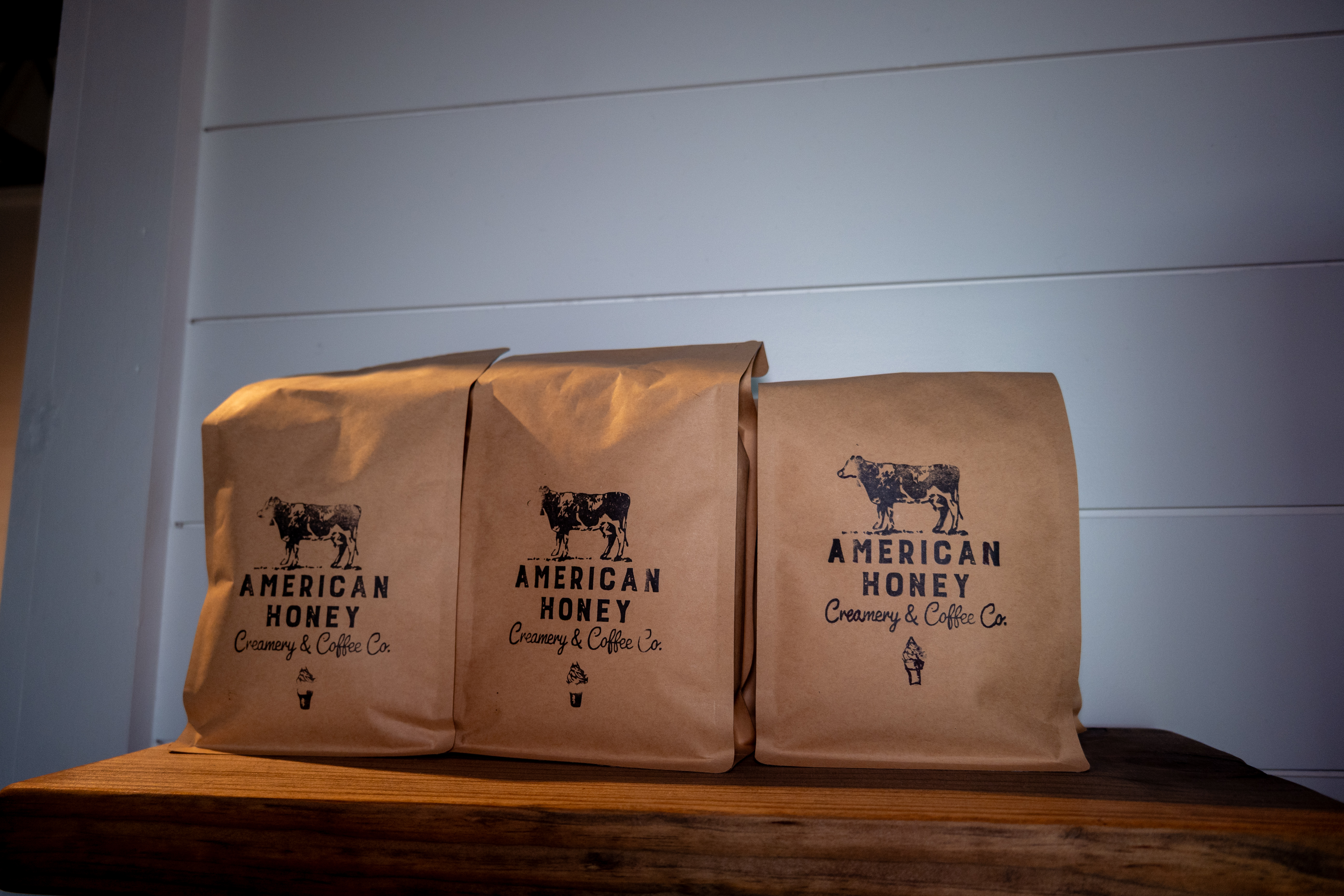 American Honey branded coffee bags on a wooden shelf